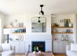 Fireplace wall. Blue veined stone fireplace with built-ins in a warm modern coastal Nova Scotia oceanfront home