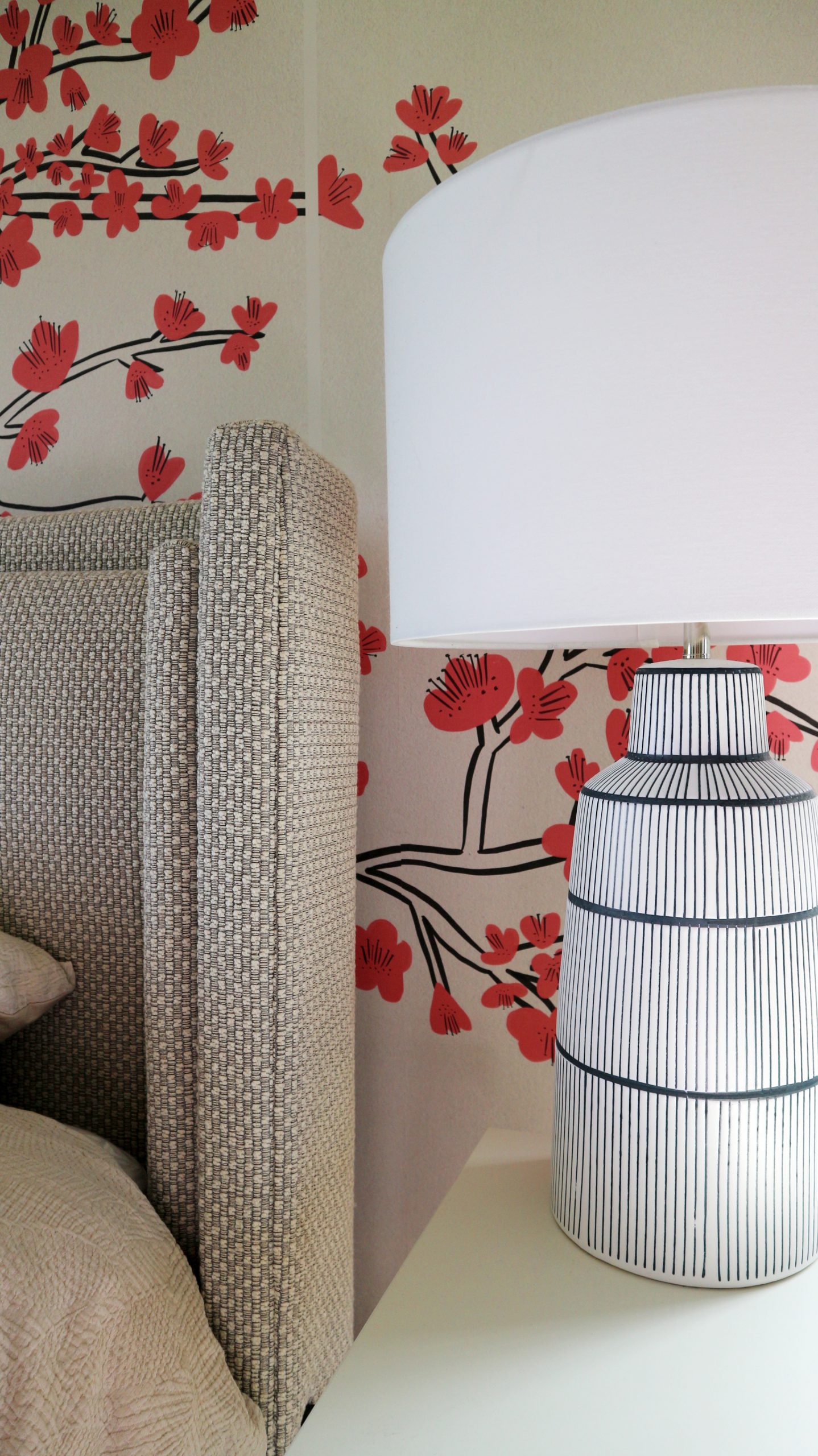 cherry blossom wallmural with woven fabric wrap headboard and navy and white lamp