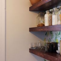 floating shelves with lemon wallpaper pantry