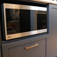microwave under counter with blue cabinets