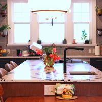 kitchen island with large window, tiled wall and open shelves