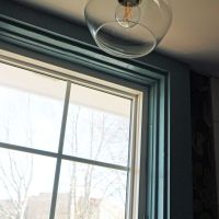 glass light fixture and window with dark blue trim