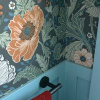 floral wallpaper blue wainscot and red hand towl